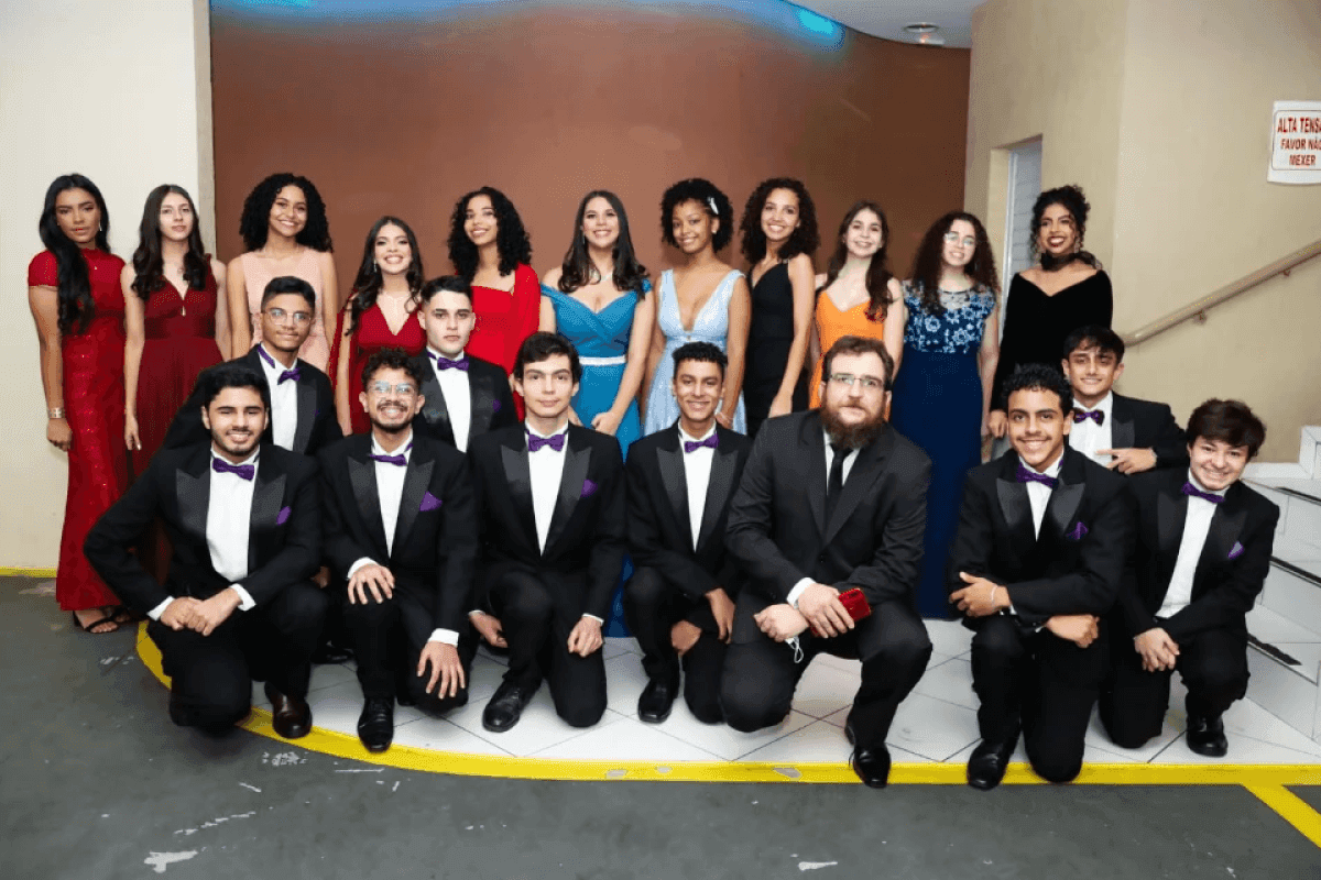 Several students and teacher wearing formal clothes.